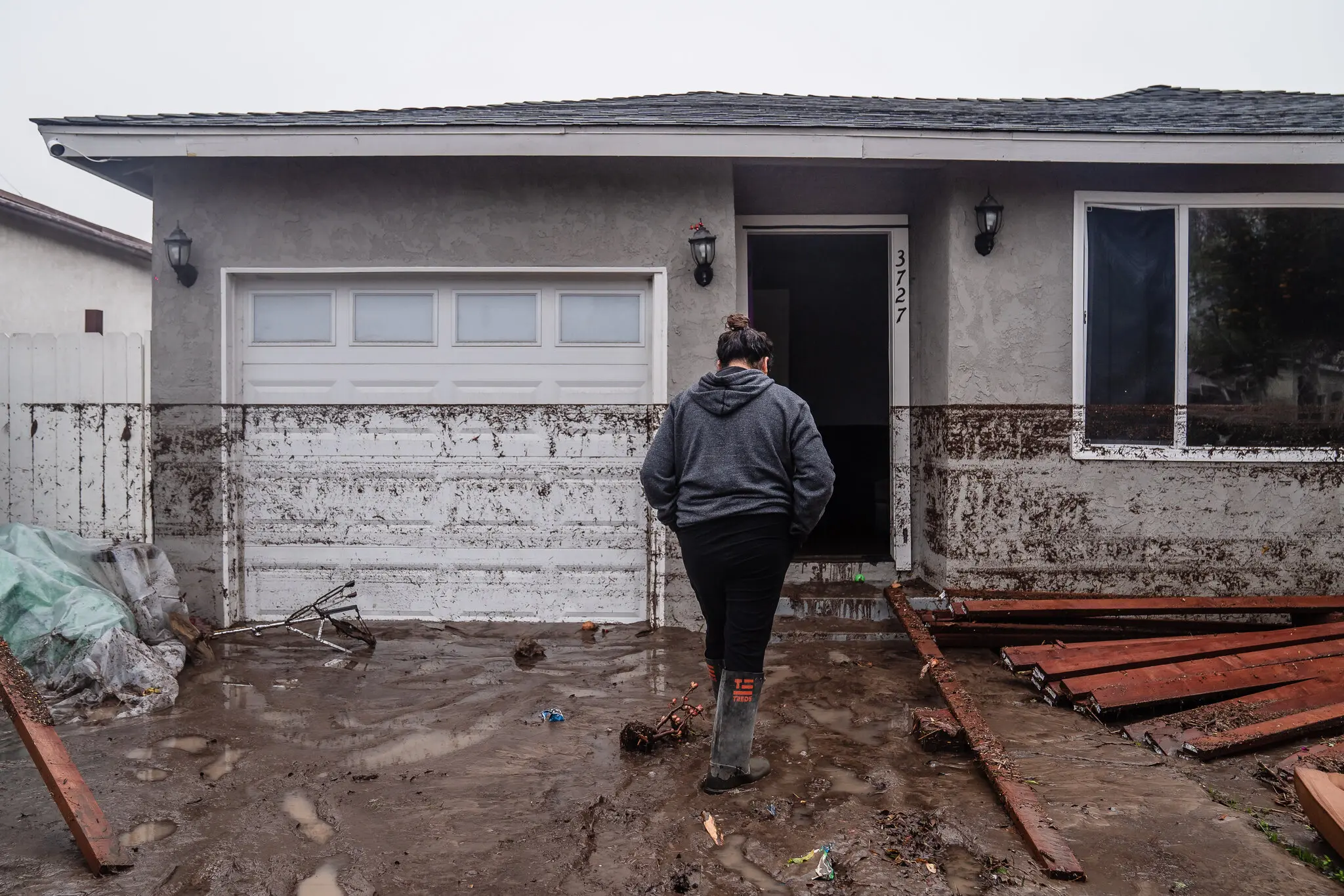 Celene Pulido’s home was flooded in San Diego on Monday. Dirt residue shows how high the water reached before receding.