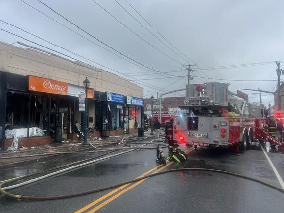 One firefighter is injured as a fire in Valley Stream sweeps through seven stores